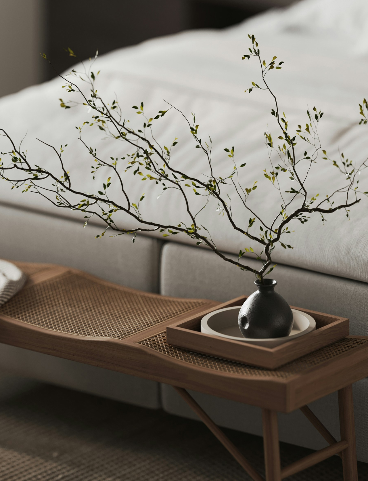 Modern home interior with a natural wood bench and decorative branch arrangement at The Lanes Nashville.