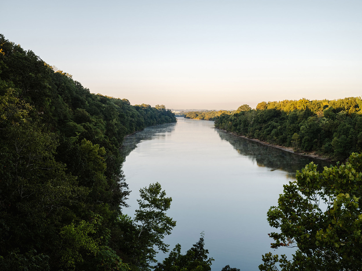 Scenic view of the Harpeth River surrounded by green hills near The Lanes home for sales in Nashville, Tennessee.